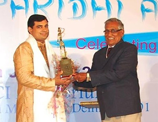 Pt. Pawan Kaushik receiving award at an event